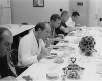 Several men at a sit-down breakfast
