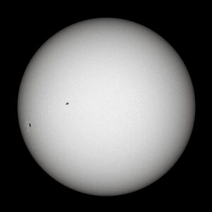 White glowing ball with black sunspots
