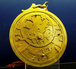 An 18th Century Persian astrolabe – maker unknown. The points of the curved spikes on the front rete plate, mark the positions of the brightest stars. The name of each star being labeled at the base of each spike. The back plate, or mater is engraved with projected coordinate lines. From the Whipple Museum of the History of Science in Cambridge.