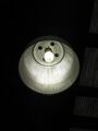 A low-bay light fixture using a high-wattage metal-halide lamp, of the type used in factories and warehouses