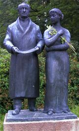 Bronze statue titled Goethe and Ulrike by Heinrich Drake, showing Johann Wolfgang von Goethe standing beside a young woman, displayed outdoors in Marienbad.