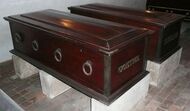 Two dark wooden coffins with metal ring handles, belonging to Johann Wolfgang von Goethe and Friedrich Schiller, displayed on stone supports in the Ducal Vault, Weimar.