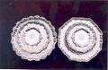 Seven salvers (c. 1735–1750). (Arms of Bisse (granted Ireland 25 May 1637): Sable three escalops in pale argent a canton ermine and a crescent for difference or. Crest: On a mount vert two snakes or, interlaced respecting each other.)