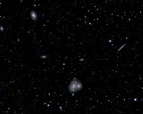 The large spiral galaxy in the center of this image is roughly 385 million light-years from Earth.