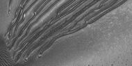 Close view of the end of gullies in Russell Crater, as seen by HiRISE Note: These types of gullies do not usually end with an apron. The location is Noachis quadrangle.