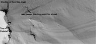 Dark slope streaks near the top of a pedestal crater, as seen by HiRISE under the HiWish program. Note in the middle of the picture, one can see the track of a boulder that rolled down a slope.