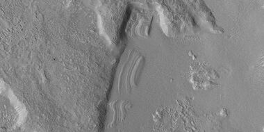 Close view of dipping layers along a mesa wall, as seen by HiRISE under HiWish program Location is Ismenius Lacus quadrangle.