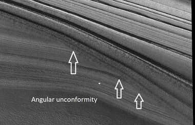 Close view of layers in northern ice cap, as seen by HiRISE under HiWish program Arrows point to an angular unconformity.