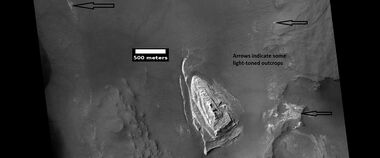 Light toned butte on floor of crater, as seen by HiRISE under HiWish program. Arrows show outcrops of light toned material. Light toned material is probably sulfate-rich and similar to material examined by Spirit Rover, and it once probably covered the whole floor. Other images below show enlargements of the butte. Location is Margaritifer Sinus quadrangle.