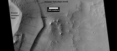 Layers under cap rock of a pedestal crater, as seen by HiRISE under HiWish program. Pedestal crater is within the much larger Tikhonravov Crater.