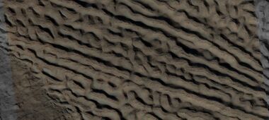 Close view of lineated valley fill (LVF) in valley, as seen by HiRISE under HiWish program. Linear valley flow is ice covered by debris. Picture is about 1 km wide. Lineated valley fill is generally considered to be and example of a glacier, as it involves the movement of ice.
