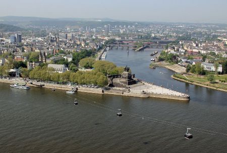 high angle view the confluence of two major rivers, marked by the statue of a man on a horse, with a city behind