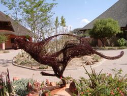 A cheetah sculpture in front of two buildings at the Cheetah Conservation Fund's Field and Research Centre in Otjiwarongo, Namibia