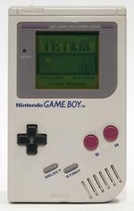 Game Boy with Tetris game on menu screen.