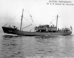 USS YP-422, a small two-masted vessel with several sailors visible on deck
