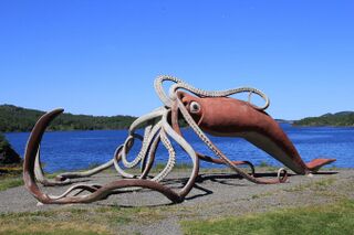 #45 (2/11/1878) A "life-sized" (55-foot) concrete and metal sculpture of the Thimble Tickle giant squid of 1878. Completed in 2001 and weighing 4 tonnes, it was designed by Don Foulds and built by him and his students, following a CA$100,000 government contribution (equivalent to United States dollar Undefined year "2,001" in 2024).[313]