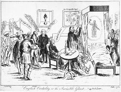 A small audience of people surround a bed, in which two children lie. A ghostly figure hovers above the children, a hammer in one hand. One man looks under the bed, with a candle. Speech bubbles are visible from each member of the audience. To the right of the image, several women are engaged in prayer.