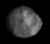 An irregularly shaped grey object slightly elongated horizontally occupies almost the whole image. Its surface shows a number of dark and white spots.