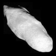 Cassini image (with moon's Saturn-facing end at lower right) reveals a surface covered with a blanket of fine material.