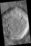 Crater floor with pits, hollows, brain terrain, and ring mold craters. These are formed when ice leaves the ground.