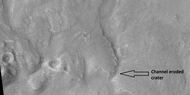 Channel that travels through part of a crater, as seen by HiRISE under HiWish program The arrow shows a crater that was eroded by the channel. Note: this is an enlargement of a previous image.