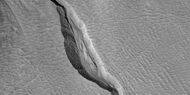 Close view of channel in gully showing streamlined forms, as seen by HiRISE under HiWish program