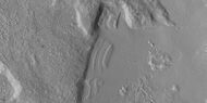 Close view of dipping layers along a mesa wall, as seen by HiRISE under HiWish program