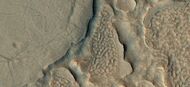 Close view of hollows formed when ice left the ground by sublimation. This was named a HiRISE picture of the day.
