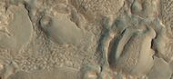 Close view of hollows formed when ice left the ground by sublimation. This was named a HiRISE picture of the day. The ridges were formed when hollows that were next to each other grew in size.