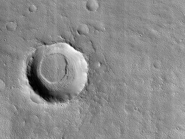 Crater with mesa. First the crater was formed. Later material was deposited in the area. That material was eroded all over, except in this crater. This image was named HiRISE picture of the day for January 18, 2024.