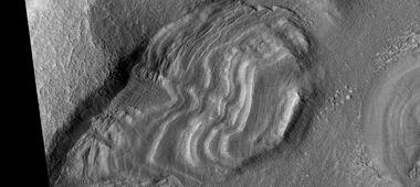Group of dipping layers. Each layer represents a change in the Martian climate.