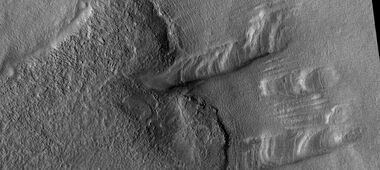 Remaining parts of a group of dipping layers. Erosion has removed most of the material.