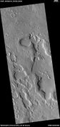 Wide view of dipping layers along mesa walls, as seen by HiRISE under HiWish program