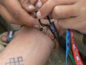 Tying friendship bracelet.jpg