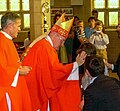 Bishop Elliott of Melbourne anointing a boy during a 2008 confirmation service