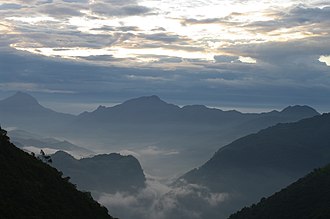 View of the rugged mountains of the Wa country with the valleys covered in mist.
