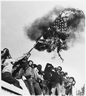 Iranian radicals burn the American flag atop the embassy.